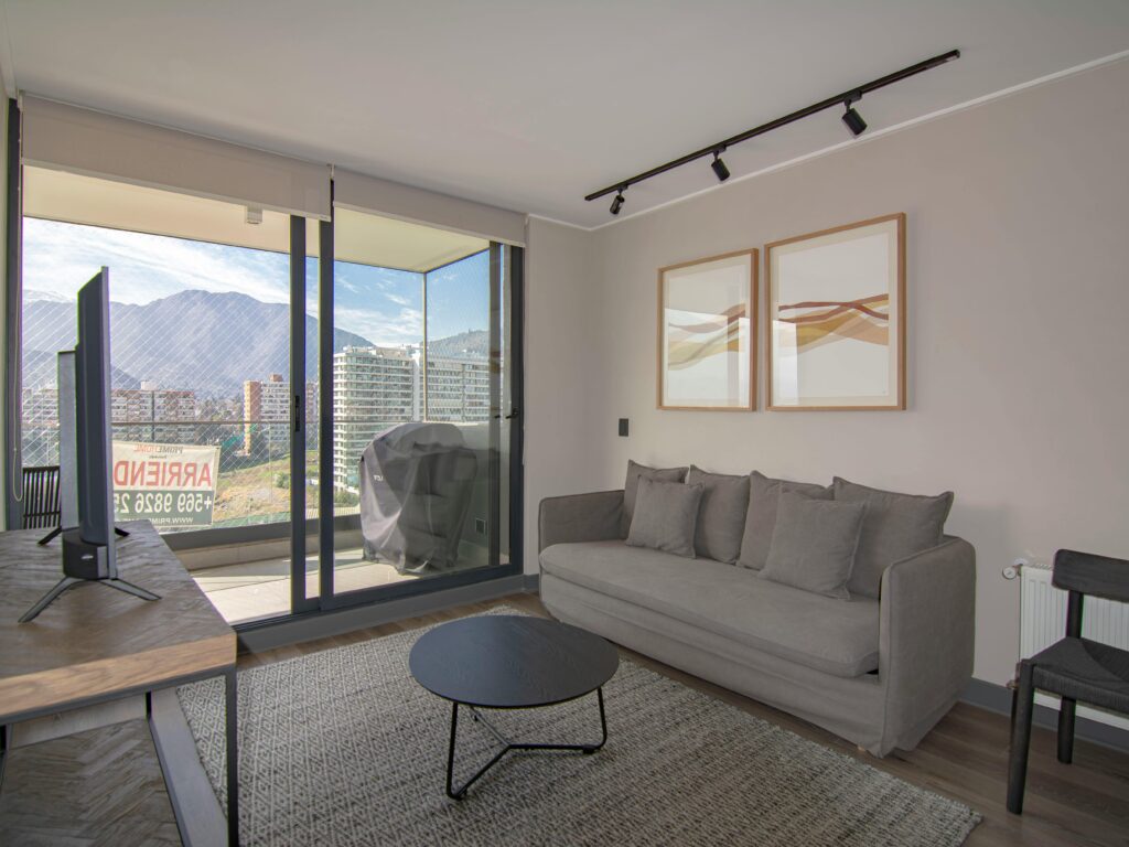 Contemporary living room featuring a cozy sofa, stylish decor, and stunning mountain view.